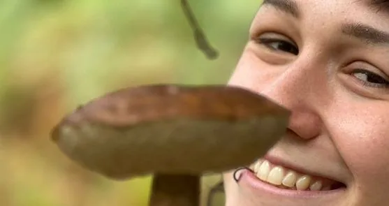 A delighted forager with a fresh woodland find